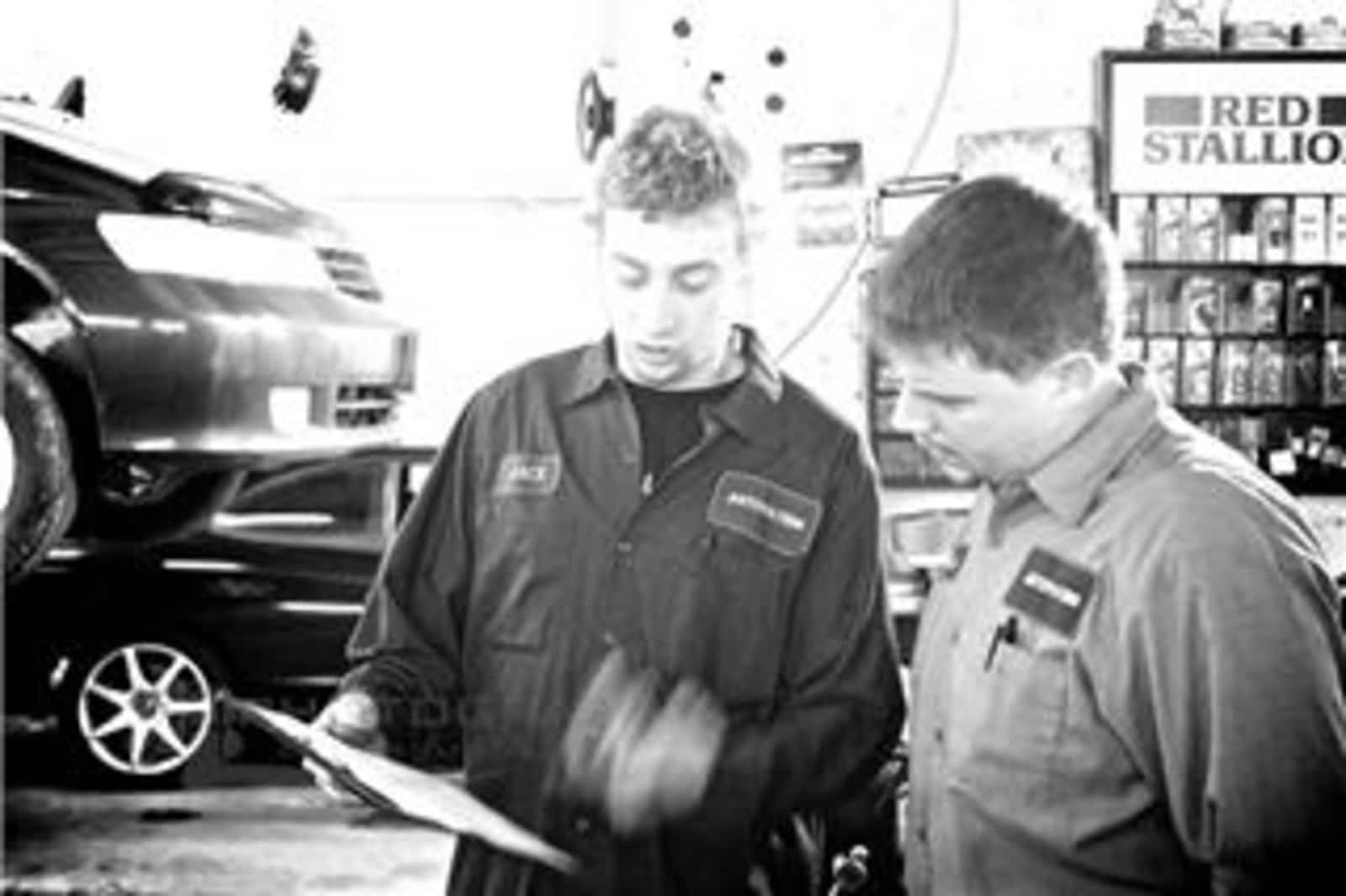 Autovation technicians reviewing a work order in the shop